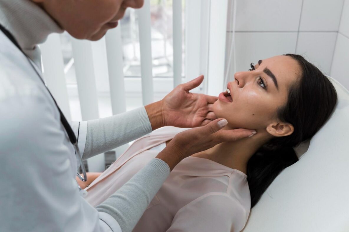 Dentist examining patient’s mouth during dental visit